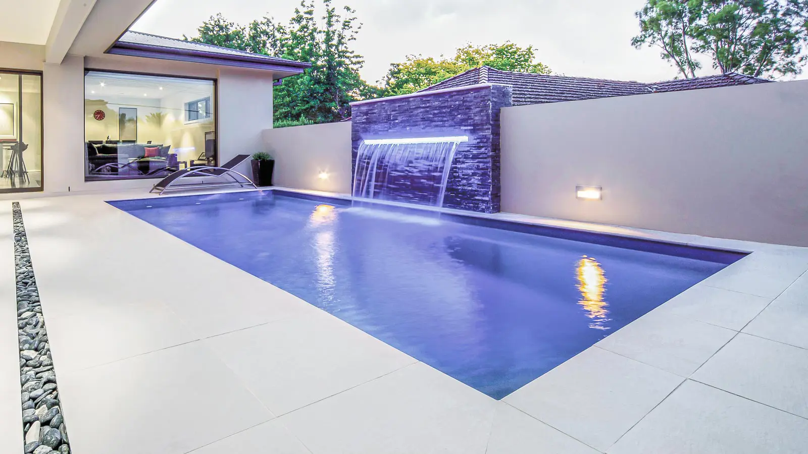 The Reflection, a fiberglass pool with full-length bench seating